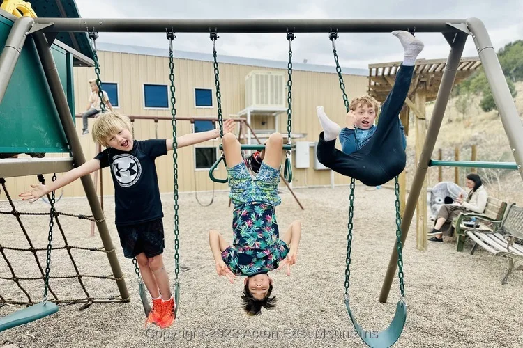 Learners at Acton Academy East Mountains near Albuquerque, New Mexico playing outside on the playground.