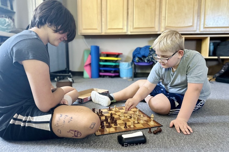 Learners at Acton Academy East Mountains private school in Cedar Crest, New Mexico playing chess. 