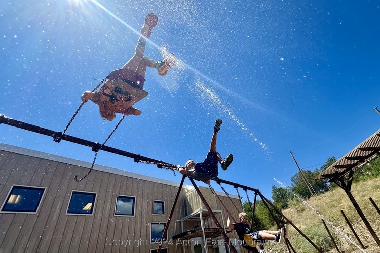 Learners at Acton Academy East Mountains private school in Cedar Crest, New Mexico playing on the swings. 